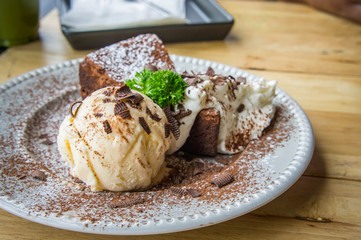 ice cream Vanilla chocolate pie whippin creamy tasty dessert on wood table in cafe ready to eat in restaurant.
