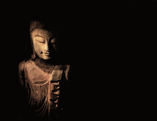 Wood Carving Buddha in Light, shallow depth of field