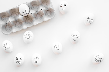 Basic emotions concept. Faces drawn on eggs. Happy, smile, sad, angry, in love. White background top view