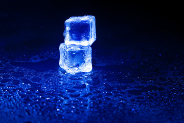 Blue ice cubes on black background.