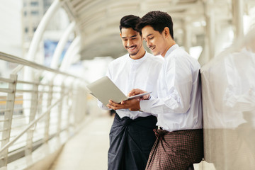 Myanmar peoples talking business in city using wireless technology