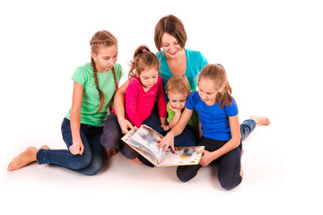 Mother reading a book to children isolated