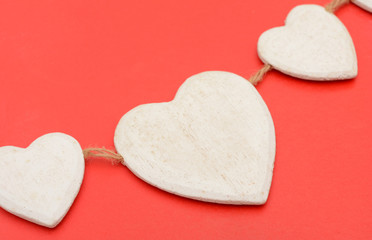 Obraz premium Closeup of Heart wooden shape on red background