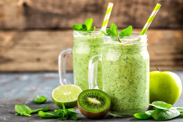 green smoothie with spinach, apple, kiwi, lime and chia seeds. healthy diet eating, superfood