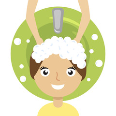 young woman and hairdresser washing her head at hair salon