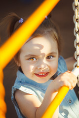 cute little child playing on playground.