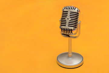 Redtro style metal microphone on yellow background