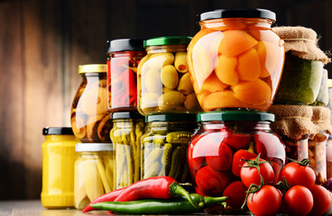 Jars with variety of pickled vegetables.