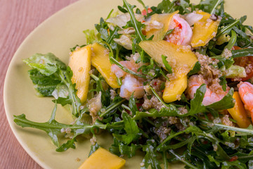 Arugula and mango, shrimps and sauce spices salad