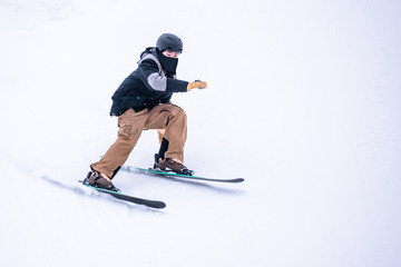 People are having fun in downhill skiing and snowboarding