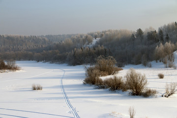 the trail from the snowmobile on the frozen lake