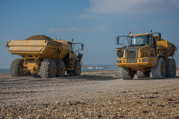 Construction Site - Engineering - Sea Defence. Large plant machinery being use to build the beach sea defence at Seaford, East Sussex, UK