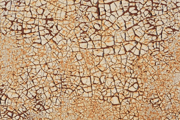 Rugged texture of finely cracked paint on rusty surface background