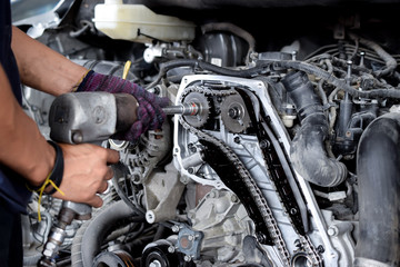 Fototapeta na wymiar Professional mechanic repairing car engine