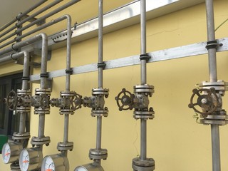 Valve with hand wheel, tubes, and flanges fitting in a factory