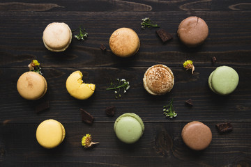 Sweet background. Delicious macaroons on the wooden table, top view