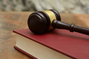 Wooden Gavel on top of a law book in court