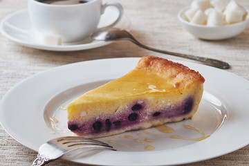 Slice of the New York cheesecake on a white plate.