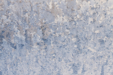 Winter frosty patterns on the frozen ice window