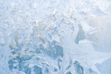 Winter frosty patterns on the frozen ice window