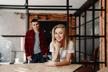 stylish young couple having fun in cozy bedroom in style loft,  feeling happy being together