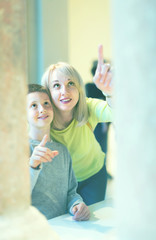 Young mother and son exploring old bas-reliefs