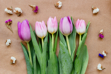 Bouquet of beautiful fresh tulips with decoration on the wooden background