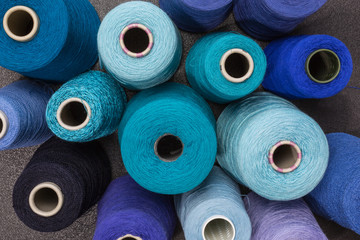 cones of wool and cotton yarn in turquois, blue and green