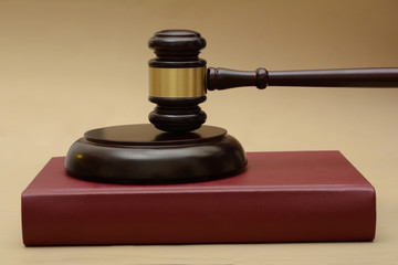 Wooden Gavel on justice red book