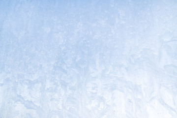 Winter frosty patterns on the frozen ice window