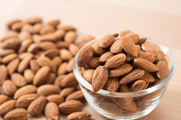 raw natural whole almonds in a cup