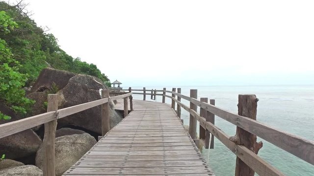 wooden bridge along the rocky coast of the island