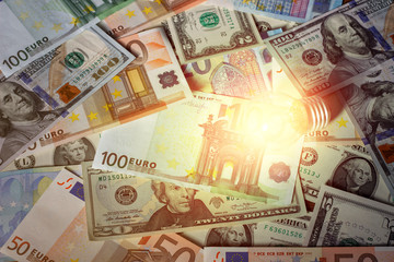 Glowing light bulb on a background of money