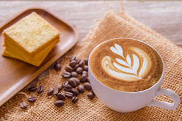 white coffee cup and roasted coffee beans around