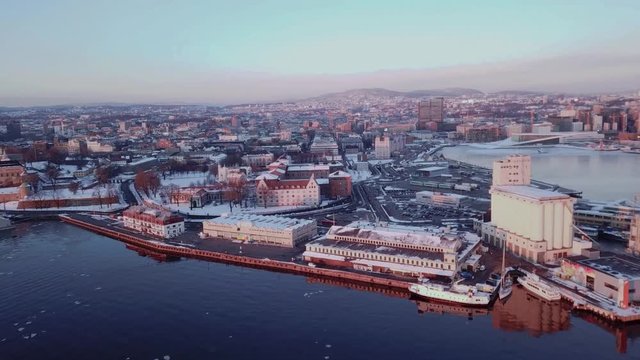 Aerial sliding shot towards Vippa and Akershus area in Oslo, Norway at sunset