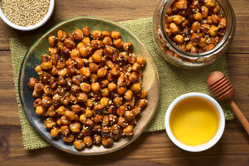 Chickpeas roasted with sesame and honey, photographed overhead on wood with natural light
