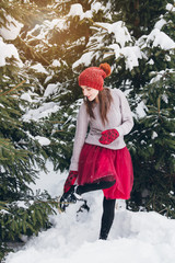 Woman having fun in winter forest