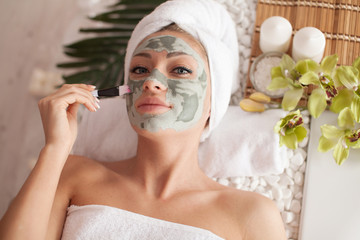 woman receiving spa treatment with cosmetic mask, skincare, antiaging, acne