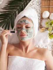 woman receiving spa treatment with cosmetic mask, skincare, antiaging, acne