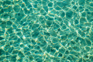 Clear blue sea water with visible bottom texture background