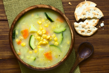 Vegetarian corn and courgette chowder served in wooden bowl, photographed overhead with natural light (Selective Focus, Focus on the soup) - obrazy, fototapety, plakaty
