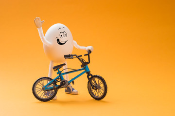 Funny egg with miniature bicycle
