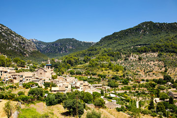 Fototapeta na wymiar View on city Valldemossa with traditional flower decoration, famous old mediterranean village of Majorca. Balearic island Mallorca, Spain