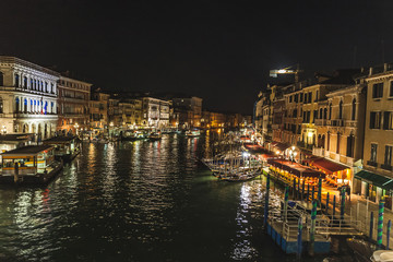 Fototapeta na wymiar Night view of the Canal Grande with illuminated houses, Venice, Italy