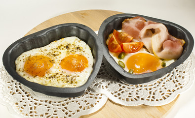 Eggs and bacon in a heart-shaped pan.