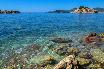 Sea. Large coastal colorful stones in the water at the shore. Clear water. Adriatic Sea