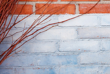 Rustic blue and brown brick wall background with dry branches