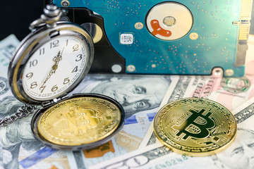 Bitcoin and pocket watch on us dollars with hard disk on back