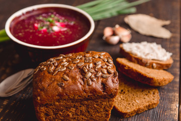 soup with onions and slices of bread on a dark wooden background