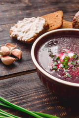 Fototapeta premium soup with onions and slices of bread on a dark wooden background